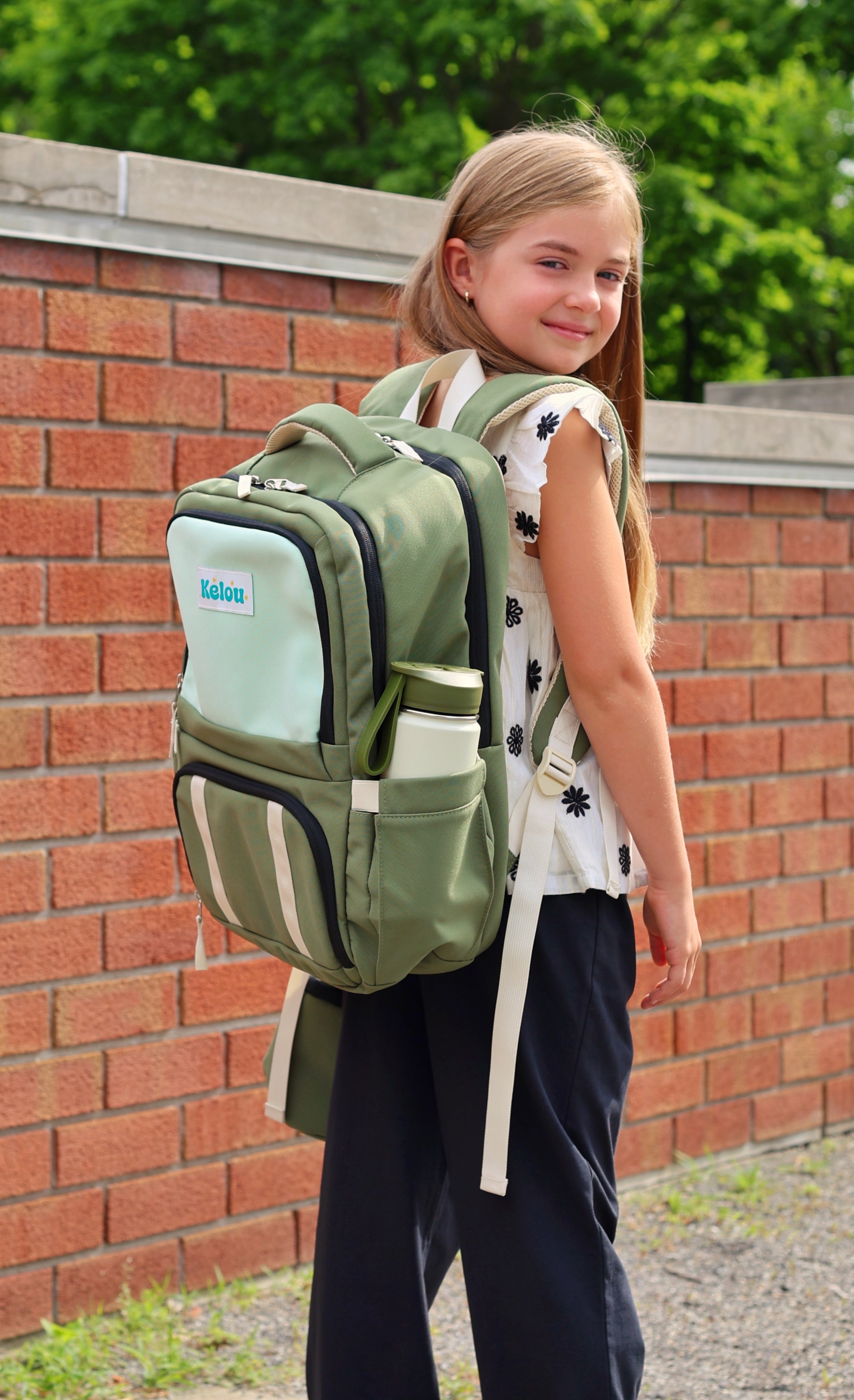 Girl wearing a green backpack outdoors