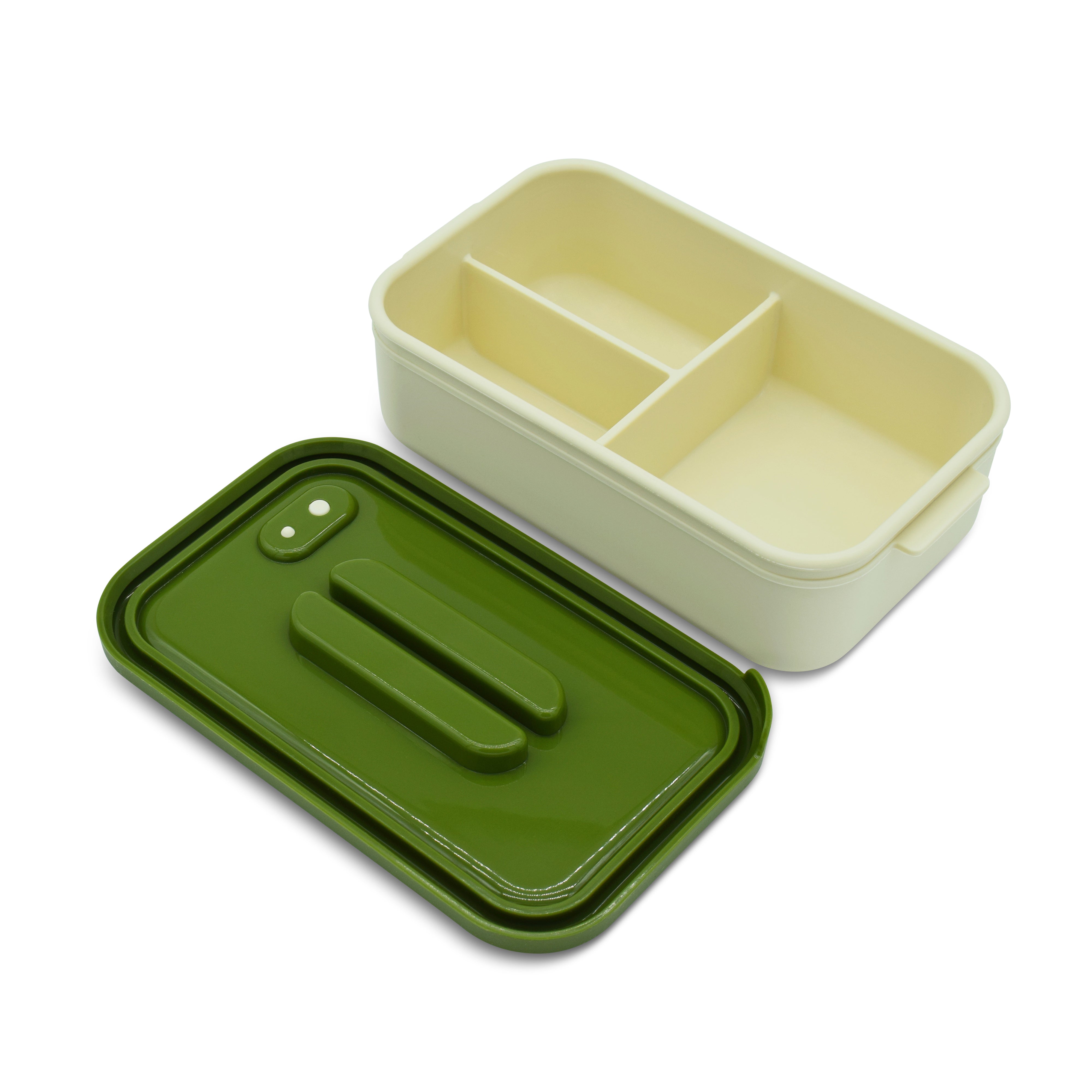 Green and beige bento box with compartments on a white background
